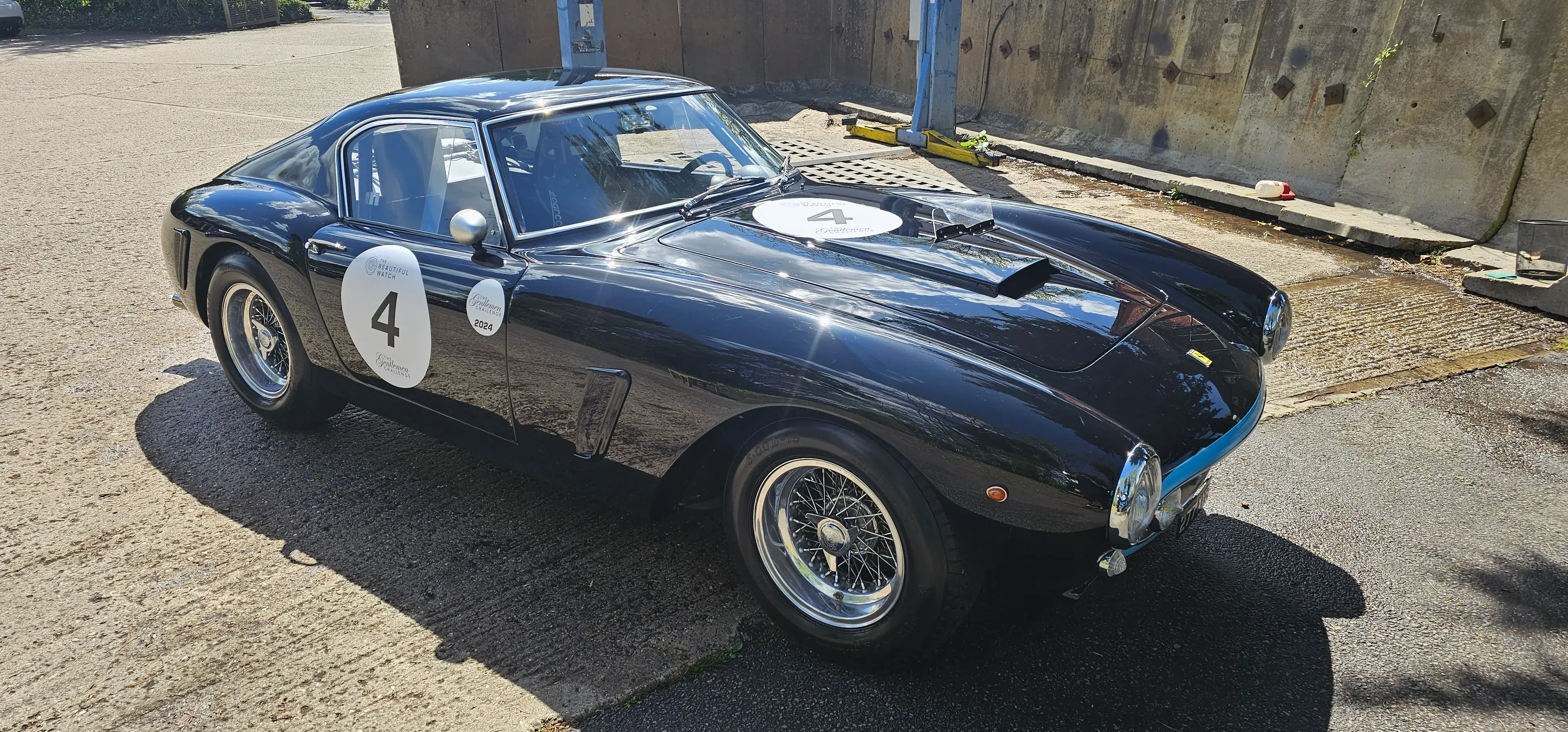 A black sports car with a number on it.