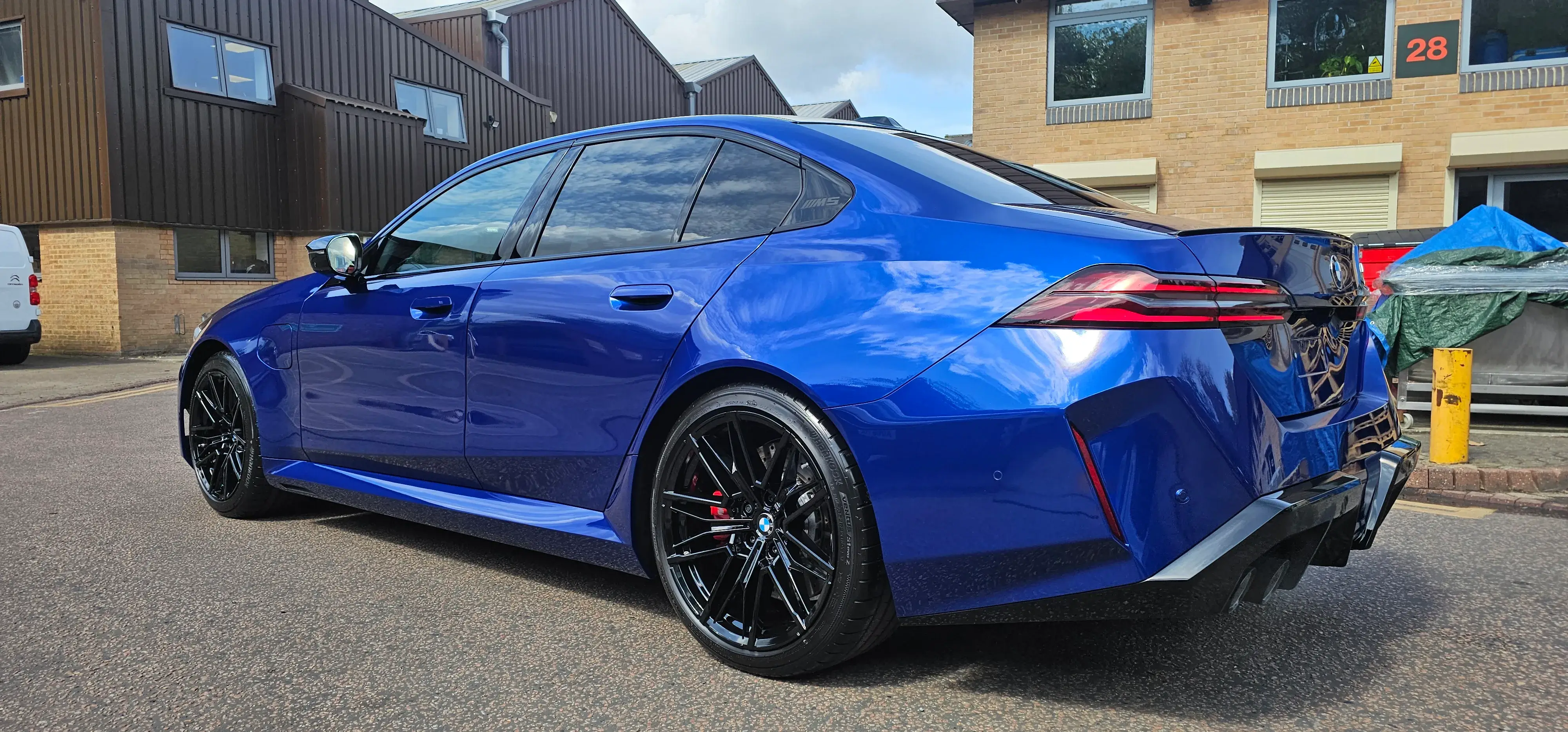 A blue car parked on the side of the road.