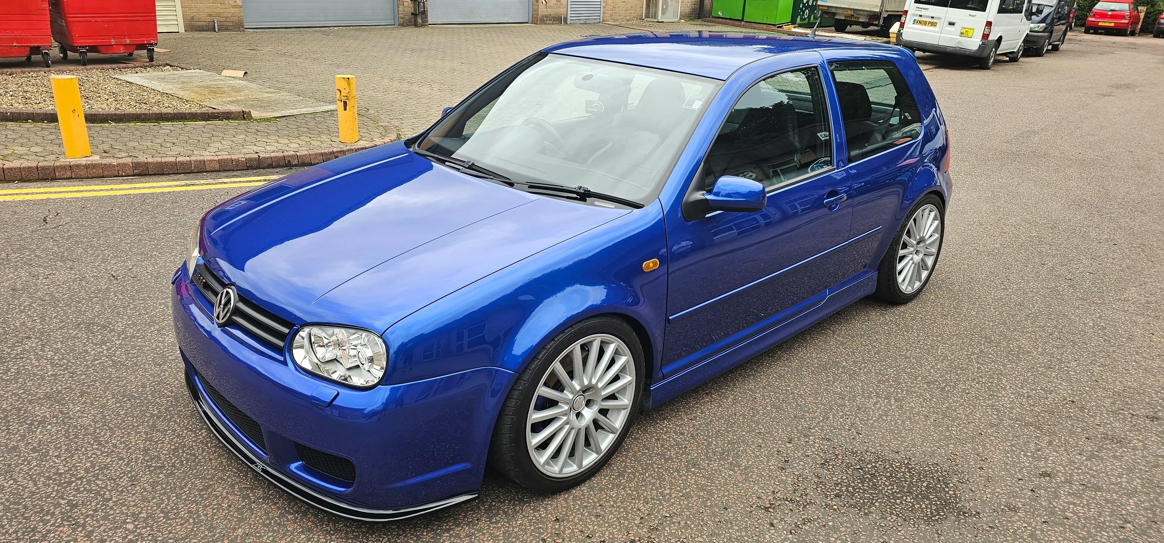 A blue car parked on the side of the road.
