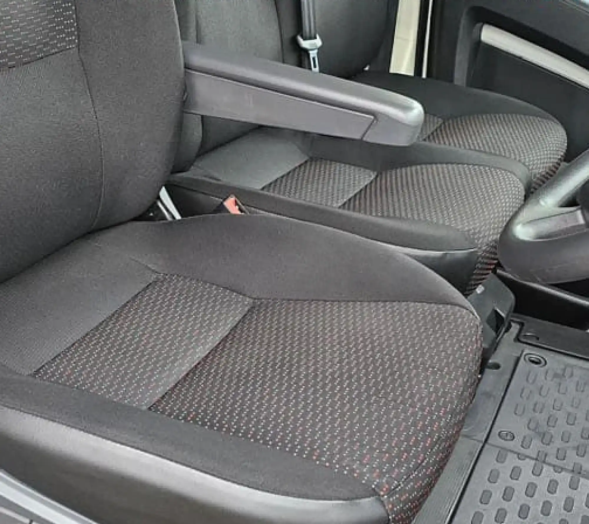 a car seat with a steering wheel and a steering wheel