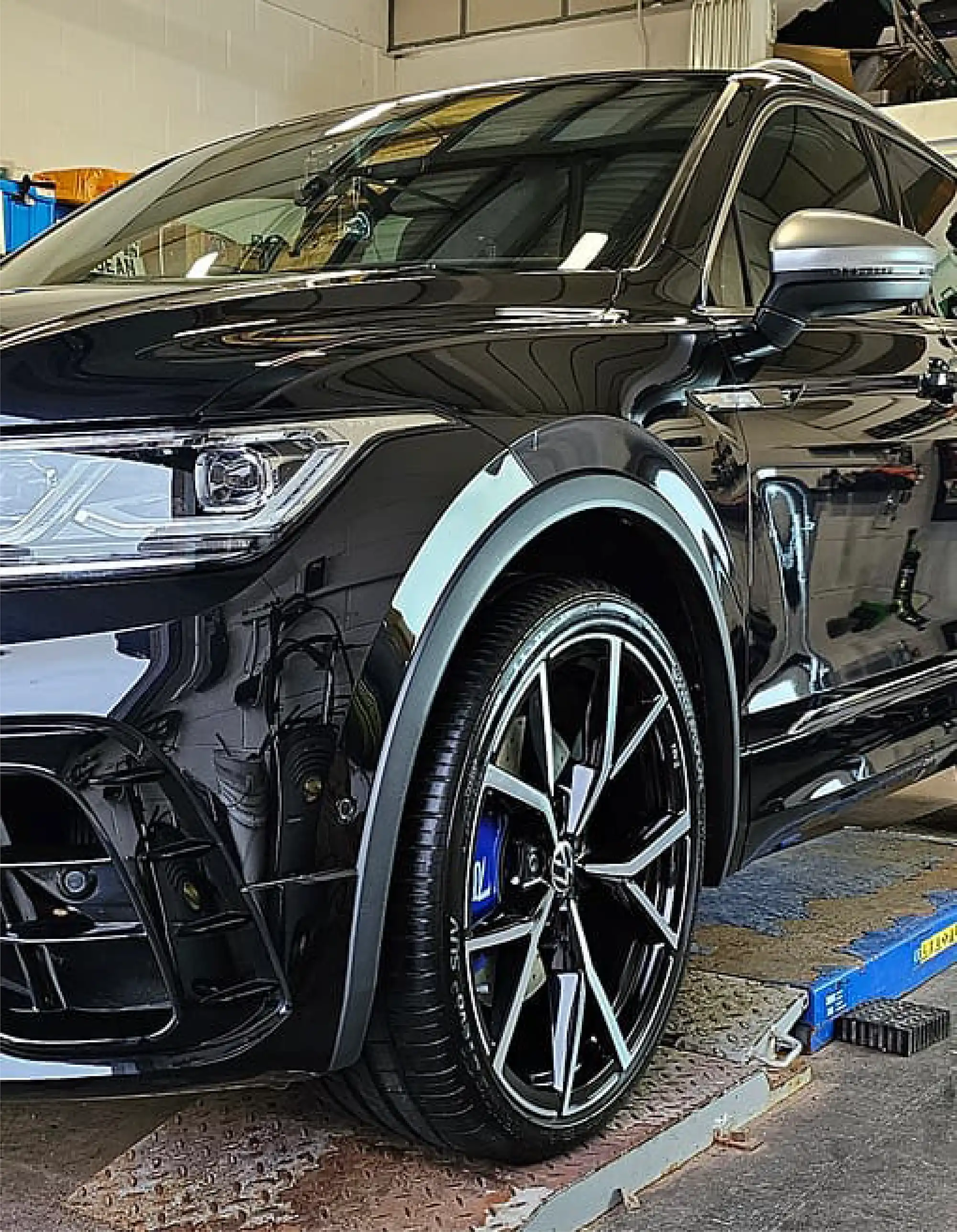 a close up of a car being worked on in a garage